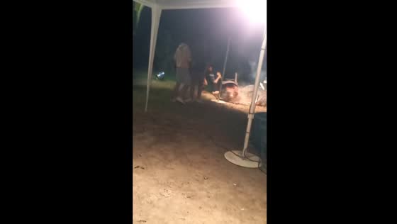 Person throws can into air and hits grill causing it to overturn