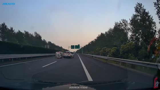 White vehicle collides with overturned van on highway in Shanghai, China