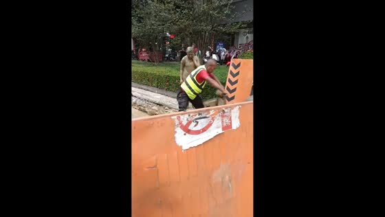 Two girls on electric scooter crash into wet cement in Hainan, China
