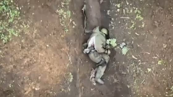 A Russian soldier throws away incoming grenades from a Ukrainian drone