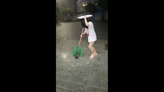 Woman catches fish during street flooding in Guangdong, China