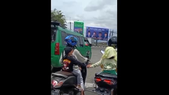 The lovely children travel separately on motorbikes and hold hands in traffic.
