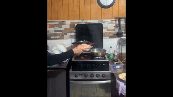 Brazilian woman spills shrimp while cooking