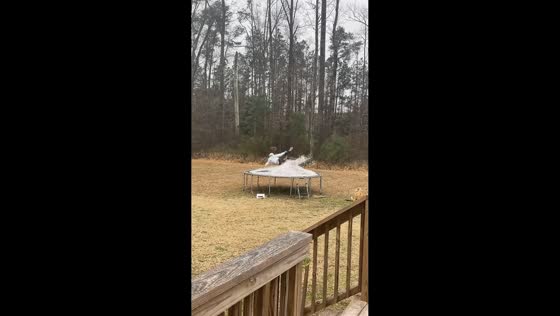 Girl slips and flips on snowy trampoline in North Carolina, USA