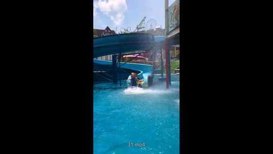 Children enjoy playful ride on water slide in Chongqing, China