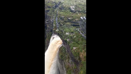 Large mist forms over waterfall in Chapada Diamantina, Bahia, Brazil