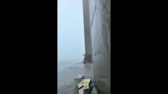 Fishermen stranded on bridge pier during violent storm in Guangdong, China