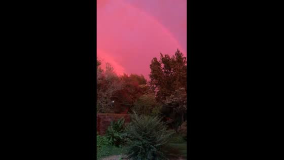 La Plata marvel: pink sky, lightning, and rainbow at dawn