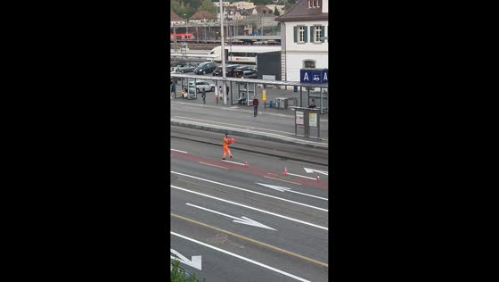 Worker skillfully kicks and catches traffic cone while clearing road in Solothurn, Switzerland