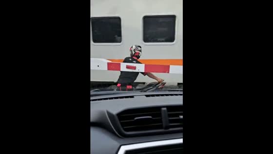 Uncontrolled motorbike riders risk lives crossing railway in Indonesia