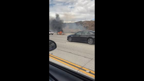 Sedan erupts in flames along I-5 freeway in Los Angeles, USA