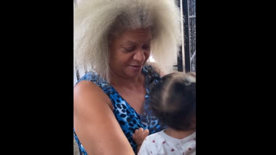 Woman with grey hair holding child compared to Thunder Sister from Croods