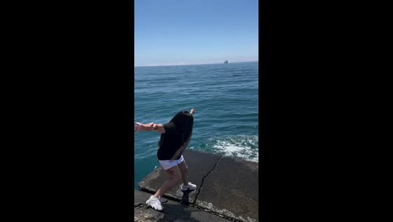 Woman slips on moss-covered pier in Yalta, Ukraine