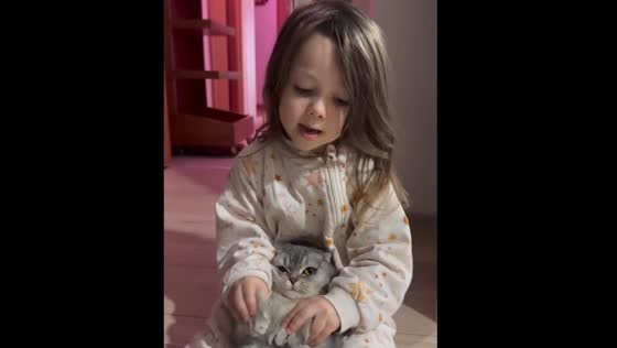   Child sings while holding cat in Istanbul, Türkiye
