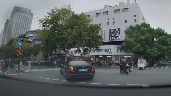 Cyclist loses balance and falls while crossing intersection in Hangzhou, China