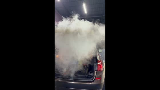 Car fills with white vapor during interior cleaning in Tashkent, Uzbekistan