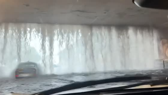 Overflowing overpass creates waterfall effect during Harbin flooding in China