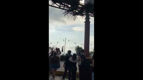 Man rides a zipline upside down in front of a crowd in Tagaytay, Philippines