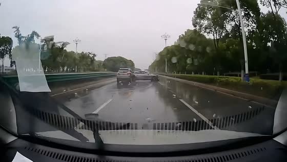 Car crashes into barrier and another vehicle on rainy road in Jiangsu, China