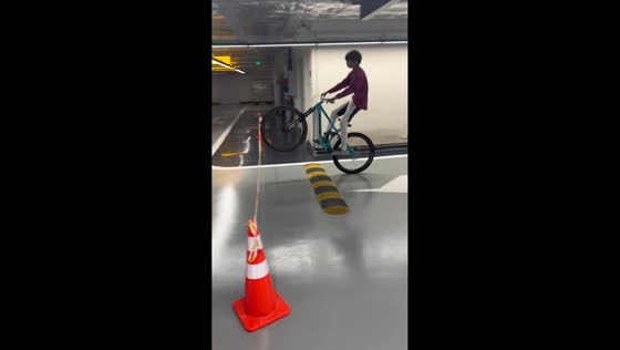 Teen bike ride hits ceiling light in underground parking in Beijing, China