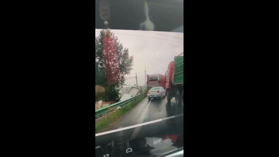 Rainy-day traffic collision causes truck to veer off road in Jilin, China