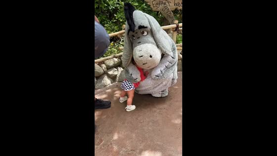 Baby shares a warm hug with Eeyore at Disneyland Park in California