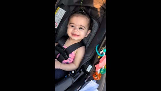 Baby startled then smiles in car seat in Mississauga, Canada