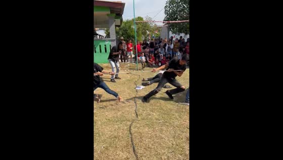 Person falls immediately after tug of war begins in Bekasi, Indonesia