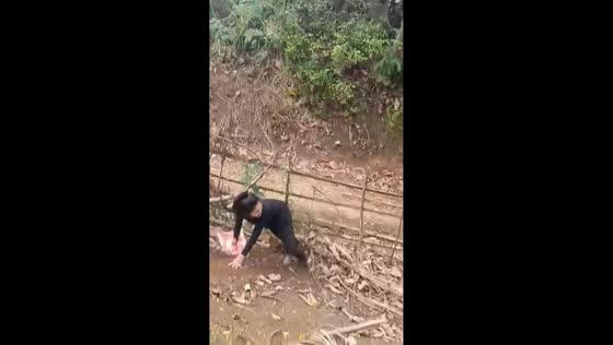 Woman attempts sack slide on hillside in Misamis Oriental, Philippines