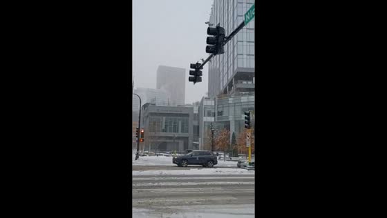 Heavy snowfall begins covering streets and buildings, Minneapolis, USA