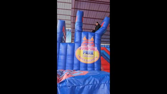Aunt and child fall onto side trampoline during playful moment in Saylla, Cusco, Peru