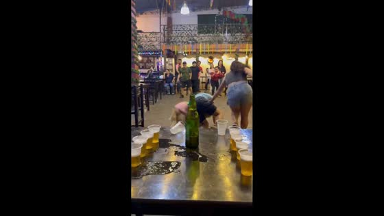 Dog playfully disrupts drinking game in San Ignacio, Peru