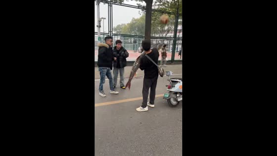 Man uses giant fish to bounce stray ball away in Hubei, China