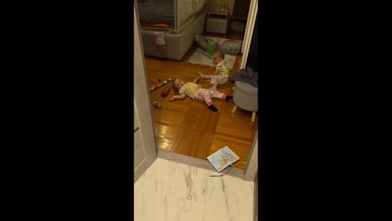 Twin toddlers tumble after playful pushing in Saint Petersburg, Russia