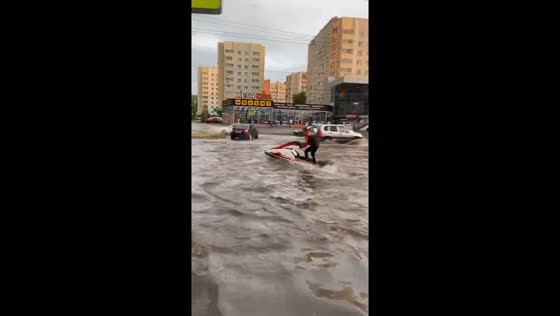 Man rides jet ski through flooded streets in Penza, Russia
