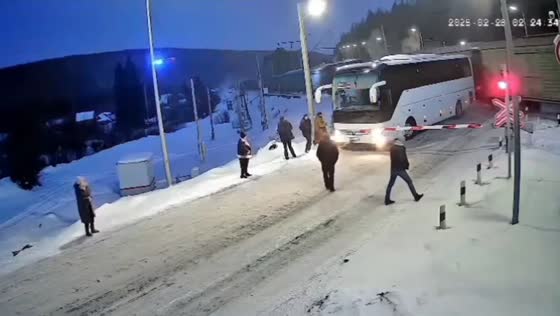 Freight train narrowly misses bus at railway crossing in Yantal, Russia