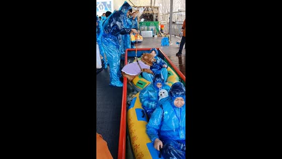 Dog joins owners on inflatable ride down water slide in Liaoning, China