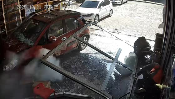 Car crashes through store's glass wall, striking a staff member during impact in Jilin, China