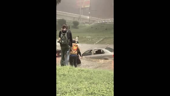 People escape car as floodwaters rise in Monterrey