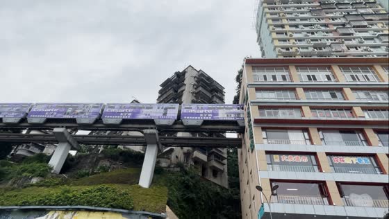 Chongqing, china: spectacular trains passing through building tunnel