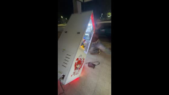 Woman accidentally topples claw machine while trying to win stuffed toy in Orán, Argentina