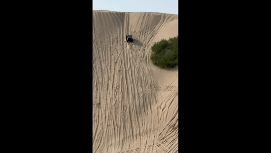 Off-road vehicle conquers steep sandy hill in Liaoning, China