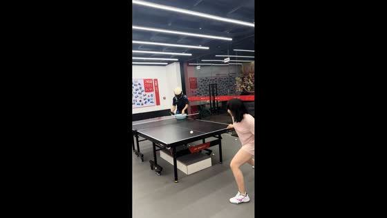 Woman plays unusual table tennis challenge with helmeted opponent in Zhejiang, China