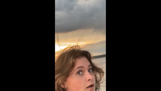 Woman gets static hair at the beach in Jacksonville, North Carolina, USA