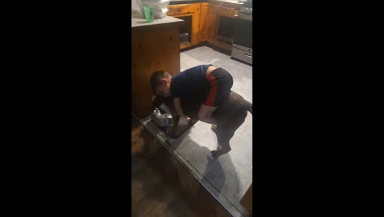 Toddler hugs dog while drinking water in Florida, USA