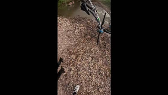 Mountain biker crashes while crossing a stream during a trail ride in Álamos, Mexico