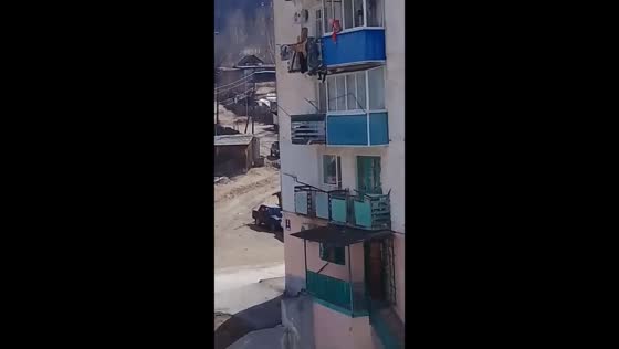 Terrifying scene unfolds as child dangles from fourth-floor balcony in Primorye, Russia