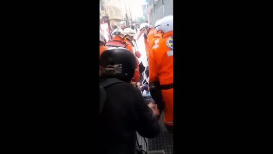 Paramedics attend to injured person amid protest in Buenos Aires