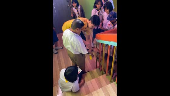 Funny rescue of a dog stuck in a fence in Thai grade school