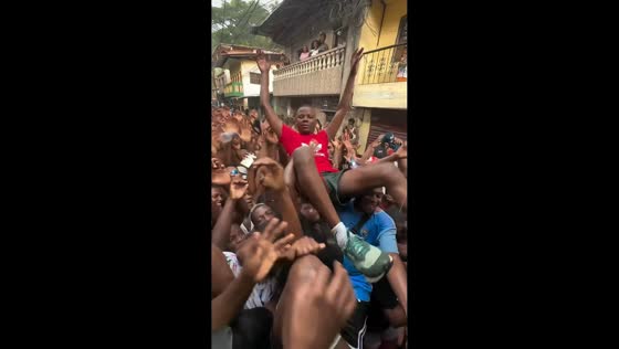 Crowd lifts revelers during traditional Bunde celebration in El Chocó, Colombia